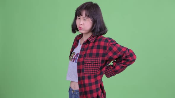 Stressed Asian Hipster Woman Having Back Pain