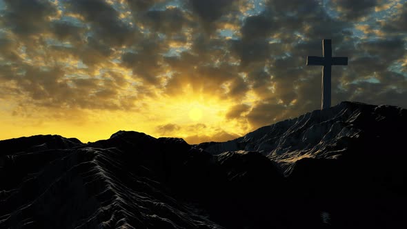 Christian or Catholic cross in the mountains against the background of clouds.