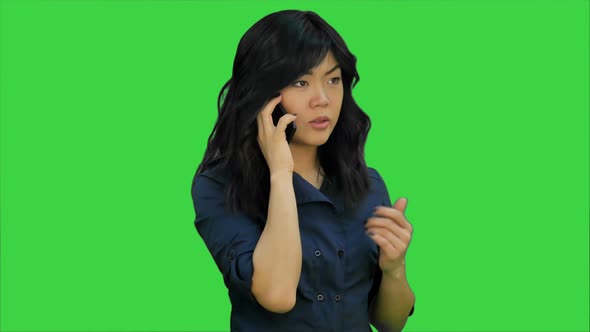 Businesswoman in Blue Suit Talking on the Cell Phone on a Green Screen, Chroma Key