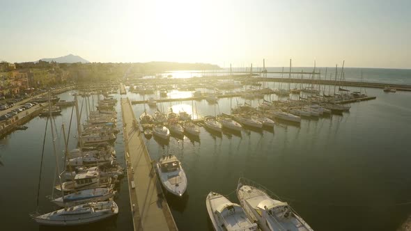 Sunlit Sailing Boats and Yachts Docked at Marina, Mediterranean Tourist City