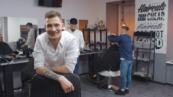 Portrait of Handsome Young Barber Smiling at Camera