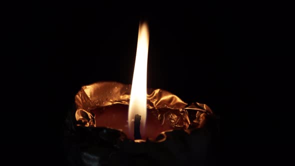 A Single Candle Flame Isolated on Dark Background Close Up View in  Footage