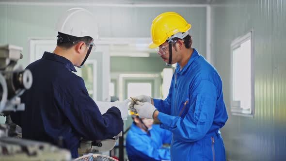 Asian mechanical technicians workers team working on milling and operating the machine in factory.