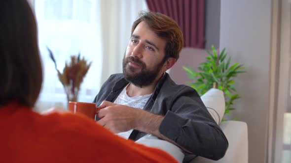 Man drinking coffee while chatting at home