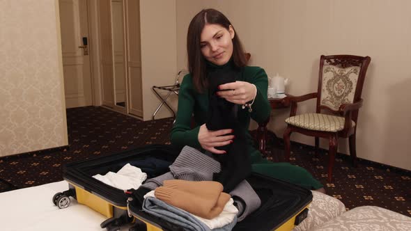 Woman Traveler Packing Clothes in Suitcase for New Journey