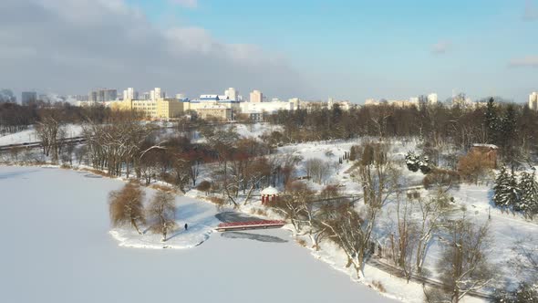 An Island on a Lake with a Bridge in the Winter Loshitsky Park