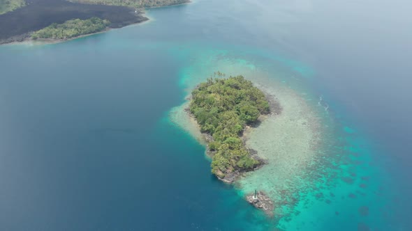 Aerial: flying over Banda Islands active volcano Gunung Api lava flows Indonesia