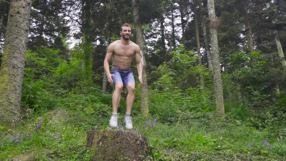 Athletic man doing jump in sport exercise in slow motion.