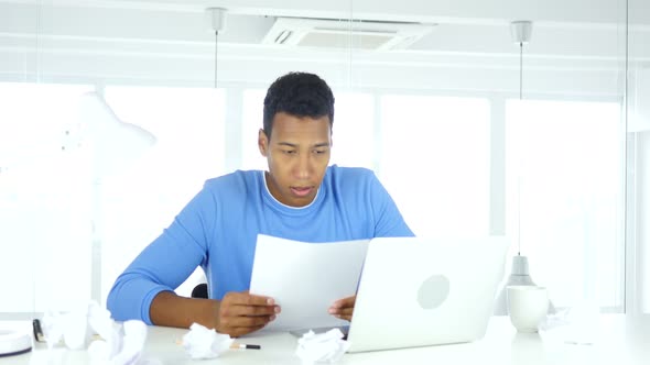 Afro-American Man Working on Documents in Office