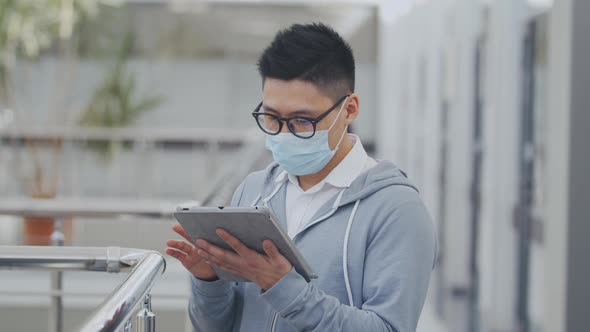 Coronavirus Covid-19 Spreading. Office Employee in Protective Mask with Tablet Pc