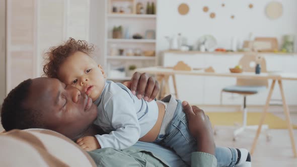 Caring Dad Patting Sleeping Cute Baby on Back