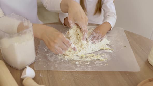 Close Up Image Woman and Little Daughter Knead Dough with Hands Wooden Table Powdered with Flour