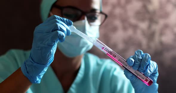 Doctor taking samples from coronavirus COVID-19 test tube