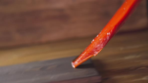 Person Raises Up and Taps Cool Smoked Salmon on Wooden Table