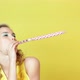 Young woman in party hat blowing party horn blower - VideoHive Item for Sale