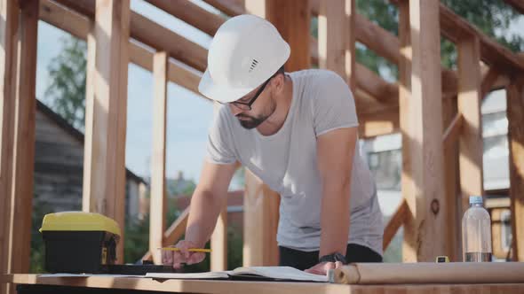 Engineer or Foreman at a Construction Site, Working with Drawings