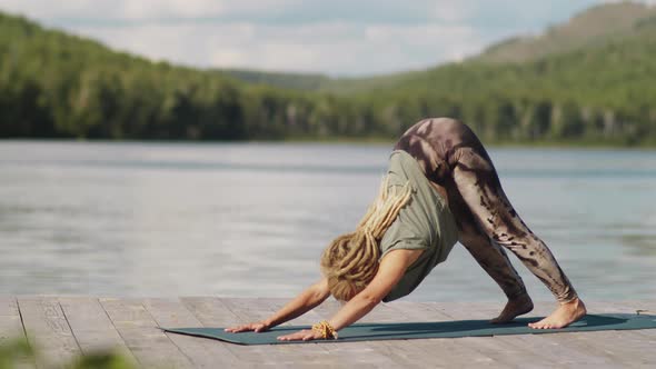 Blonde Woman Practicing Yoga Outdoors on Lake Pier