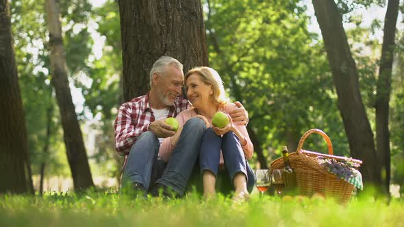 Family Weekend, Retired Couple Sitting in Park and Eating Green Apples, Picnic