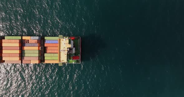 Shipping containers stacked on a sailing Container ship, Top down shot.