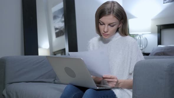 Young Woman Reading Letter, Working on Laptop