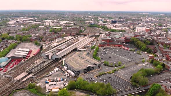 Reverse aerial view of Preston train station on a cloudy day