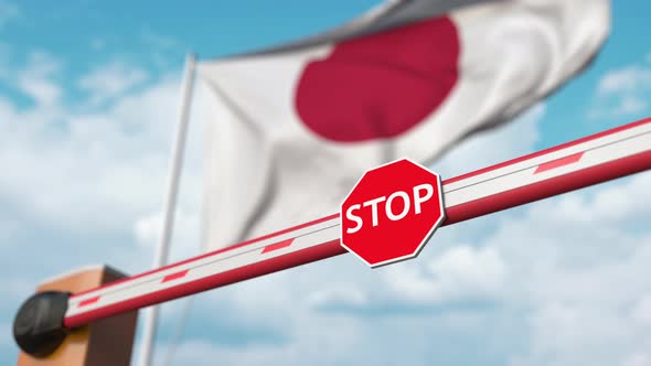 Barrier Gate Being Opened with Flag of Japan As a Background alt