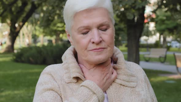 Elderly Aged Woman Unhealthy Lady of Retirement Age Touching Neck Suffering From Angina