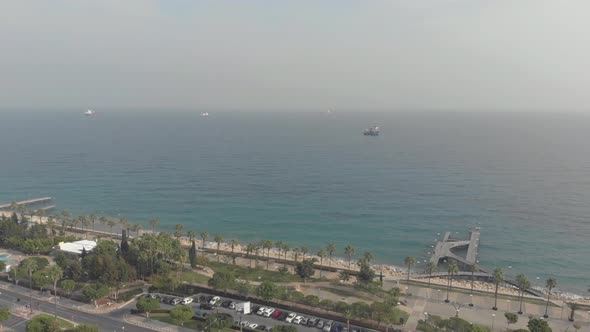 Aerial View 4K drone shot of Limassol's Sea boulevard with palmtrees, Cyprus