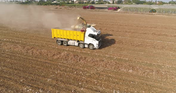 Aerial view of a tractor and a lorry working in a field, Kibbutz Saar, Israel.