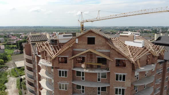 Aerial Construction of a Brick House. Installation of Wooden Roof