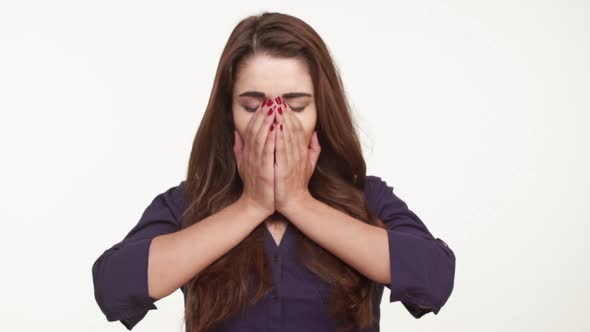 Beautiful Caucasian Female with Long Brown Hair and Dark Blue Shirt Yawning Stretching Standing on