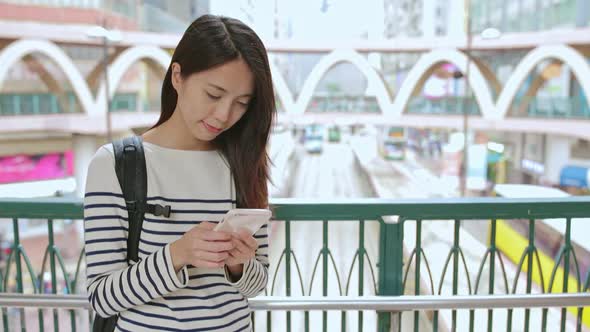 Woman using cellphone in the city of Hong Kong 