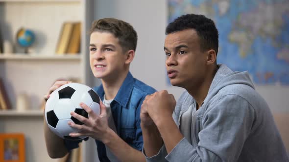 Afro-American and Caucasian Guys Disappointed With Football Team Losing Match