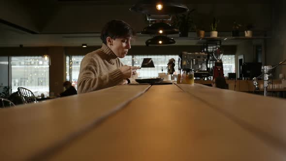 Side View A Lonely Girl Eating Salad Sitting at a Restaurant Table