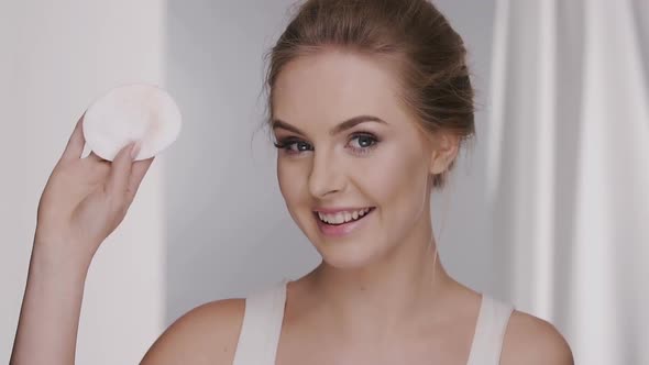 Woman Wiping Her Face and Showing Cotton Pad To the Camera