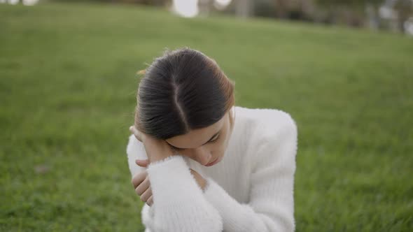 Portrait Shot of Young Woman Outdoors with Tired and Sad Expression