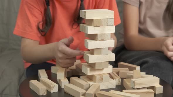 Taking wooden bricks from tower. 