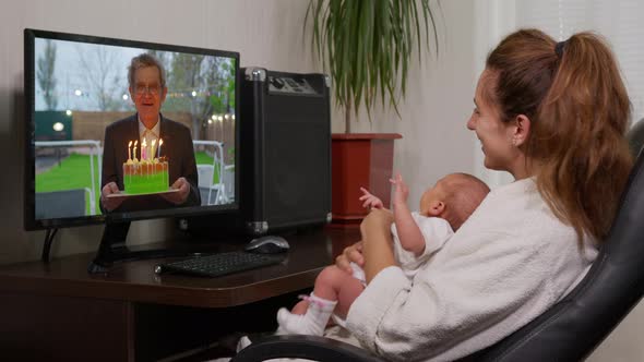 Father Congratulating a Woman on Her Birthday Using a Video Call. Home Quarantine, Social Distancing