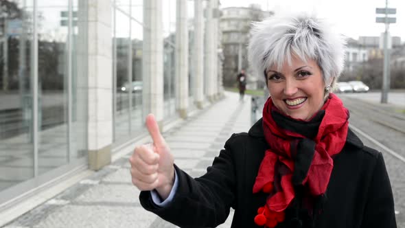 Business Middle Aged Woman Shows Thumb on Agreement - Urban Street with Cars in City