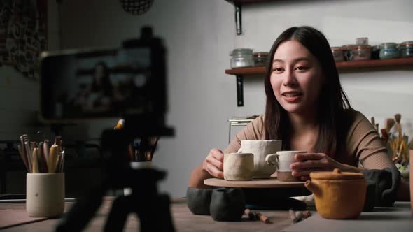 A young Asian woman ceramist is showcasing new pottery works via social media.