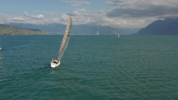 Inspiring Aerial of boat sailing on a vast and beautiful lake in summer