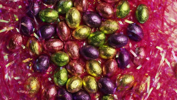 Rotating shot of colorful Easter candies on a bed of easter grass 