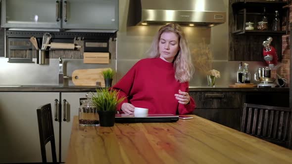 Freelancer woman mug coffee comes to table with laptop, opens it starts working