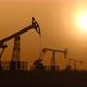 Oil Pump Jacks in the Desert Extracting Crude Oil against Sunset  - VideoHive Item for Sale