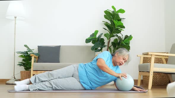 Asian senior woman stretching for exercise and workout at home. Active mature woman doing stretching