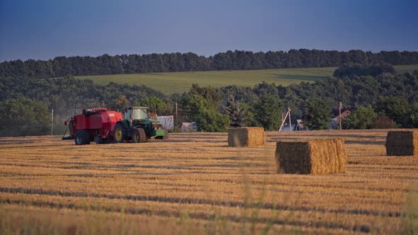 Square bales and a tractor on the field