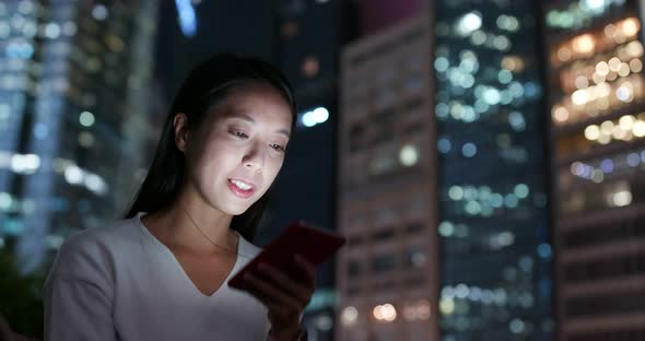 Woman work on cellphone in city