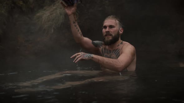 Man Throws a Cloth As He Relaxes on a Stream