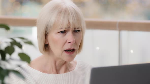 Closeup Frustrated Mature Businesswoman Looking at Laptop Screen Reading Email Stunned Shocked By
