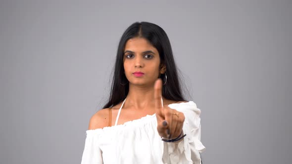 Indian girl saying no and waving finger